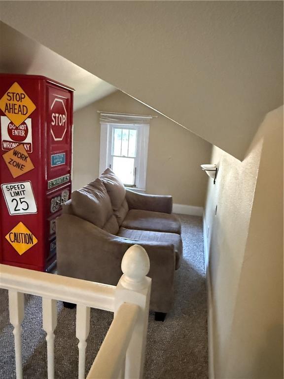 418 N 8th St, Independence, KS 67301 - carpeted living room featuring vaulted ceiling and baseboards