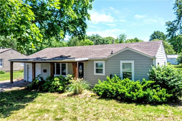 7041 Garnett St, Shawnee, KS 66203 - view of front of property featuring a front yard and a garage