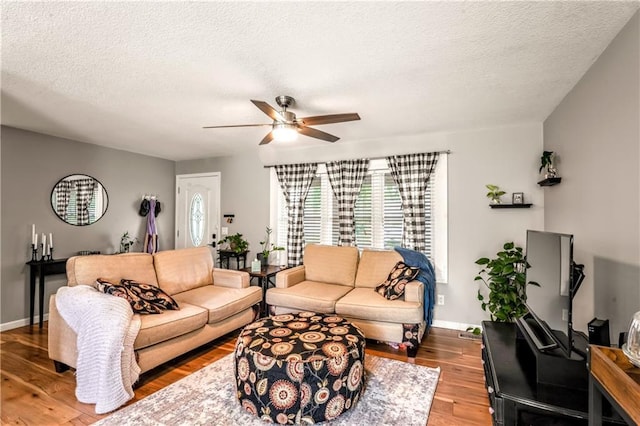 7041 Garnett St, Shawnee, KS 66203 - living area with ceiling fan, wood finished floors, a textured ceiling, and baseboards