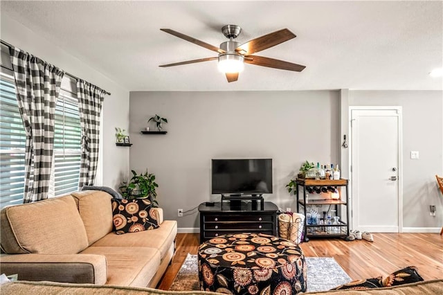7041 Garnett St, Shawnee, KS 66203 - living room with ceiling fan, wood finished floors, and baseboards