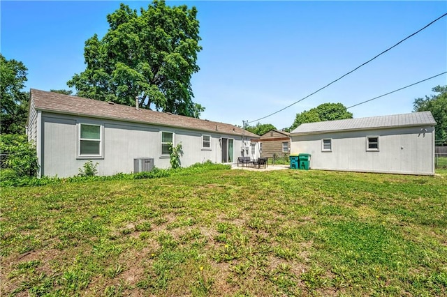 7041 Garnett St, Shawnee, KS 66203 - back of property featuring a yard, a patio area, and central AC unit