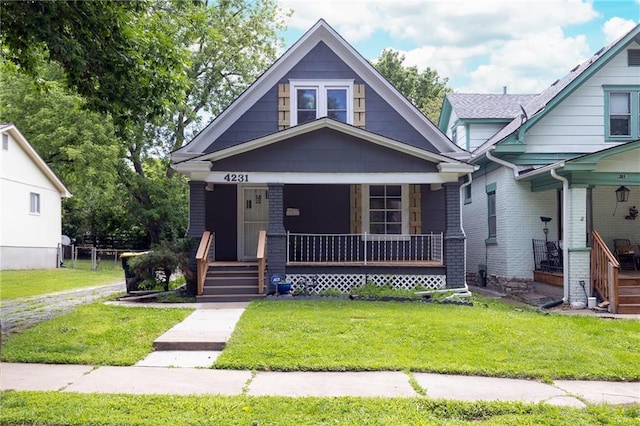 4231 Wyoming St, Kansas City, MO 64111 - view of front facade with covered porch and a front lawn