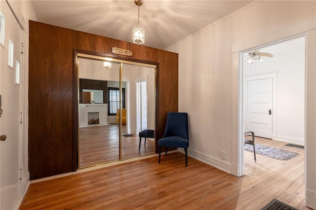 4231 Wyoming St, Kansas City, MO 64111 - living area featuring wood finished floors, ornamental molding, baseboards, and plenty of natural light