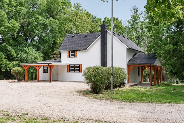 23852 Haigwood Rd, Tonganoxie, KS 66086 - view of front of home featuring dirt driveway, a chimney, and a shingled roof