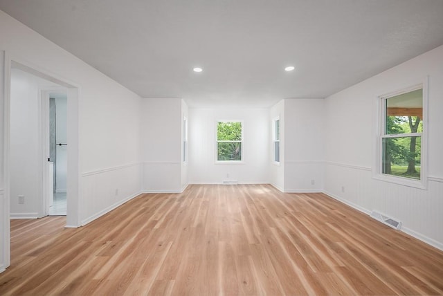23852 Haigwood Rd, Tonganoxie, KS 66086 - spare room featuring light wood-style flooring, recessed lighting, baseboards, and wainscoting