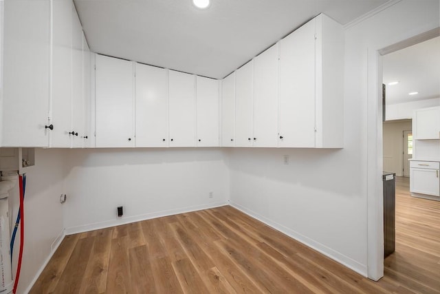 23852 Haigwood Rd, Tonganoxie, KS 66086 - laundry area featuring cabinet space, light wood-style flooring, recessed lighting, baseboards, and washer hookup