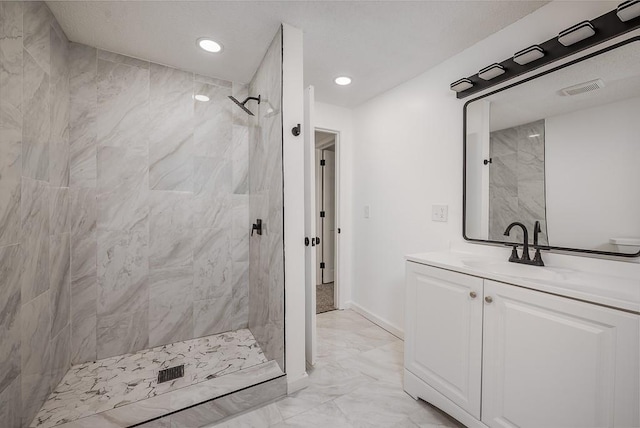 23852 Haigwood Rd, Tonganoxie, KS 66086 - bathroom featuring marble finish floors, a tile shower, vanity, recessed lighting, and baseboards