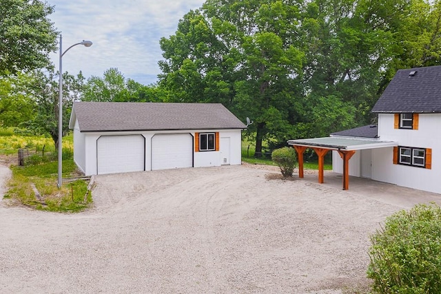 23852 Haigwood Rd, Tonganoxie, KS 66086 - detached garage with view of wooded area