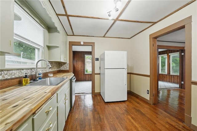 409 N Elmwood Ave, Kansas City, MO 64123 - kitchen with freestanding refrigerator, a sink, butcher block counters, and dark wood-type flooring
