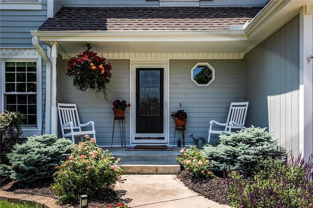 14169 W 115th Ter, Olathe, KS 66062 - view of exterior entry featuring a porch and a shingled roof
