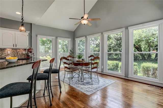 14169 W 115th Ter, Olathe, KS 66062 - dining area featuring wood finished floors, a ceiling fan, vaulted ceiling, and recessed lighting