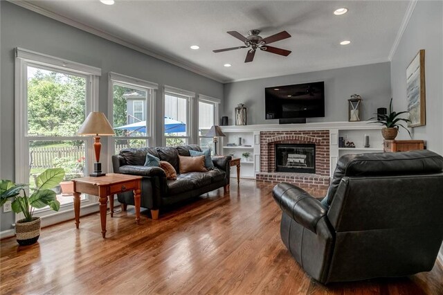 14169 W 115th Ter, Olathe, KS 66062 - living area featuring crown molding, healthy amount of natural light, wood finished floors, recessed lighting, and ceiling fan