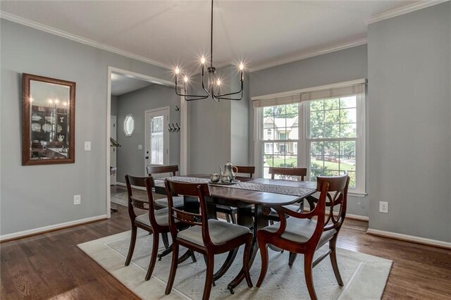 14169 W 115th Ter, Olathe, KS 66062 - dining room featuring wood finished floors, crown molding, and a chandelier