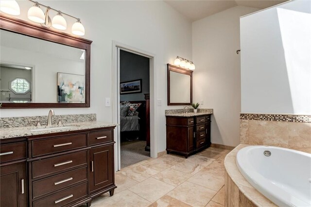 14169 W 115th Ter, Olathe, KS 66062 - ensuite bathroom featuring two vanities, a garden tub, and vaulted ceiling