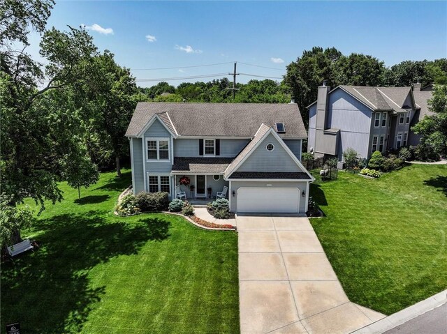 14169 W 115th Ter, Olathe, KS 66062 - view of front of home with a front yard, driveway, a garage, and a porch