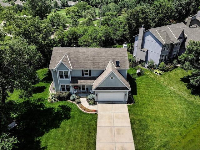 14169 W 115th Ter, Olathe, KS 66062 - view of front of house with concrete driveway, a front lawn, an attached garage, and a chimney