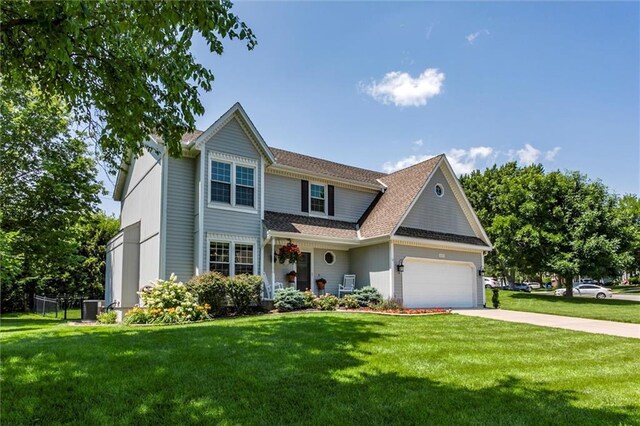 14169 W 115th Ter, Olathe, KS 66062 - traditional-style home featuring a garage, a front lawn, concrete driveway, and roof with shingles