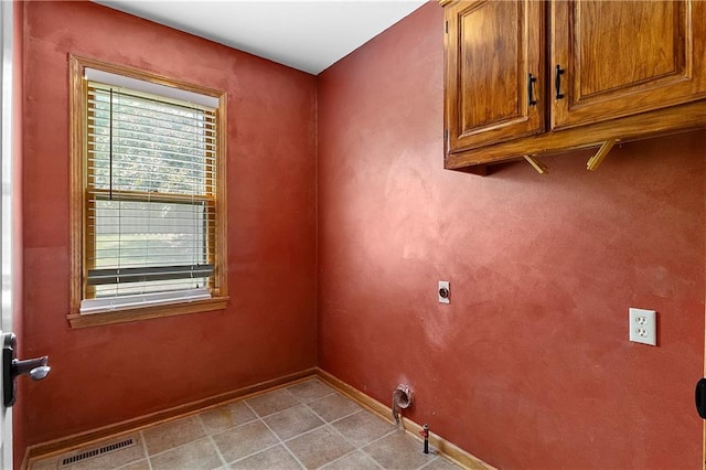 11207 W 109th St, Overland Park, KS 66210 - laundry area featuring cabinet space, baseboards, and electric dryer hookup