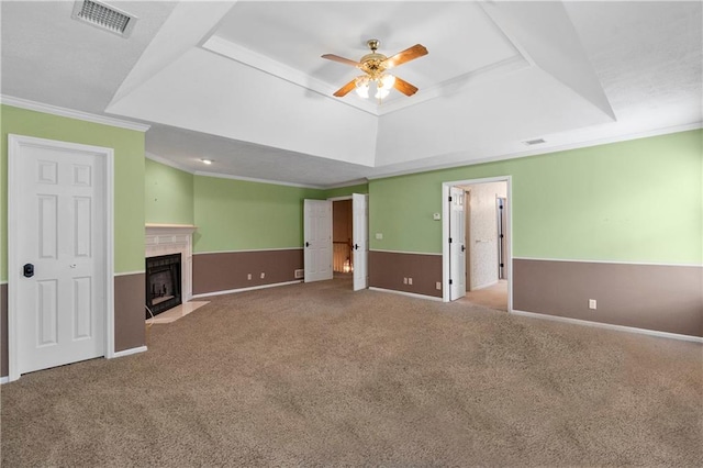 11207 W 109th St, Overland Park, KS 66210 - unfurnished living room featuring a raised ceiling, ceiling fan, ornamental molding, carpet floors, and baseboards