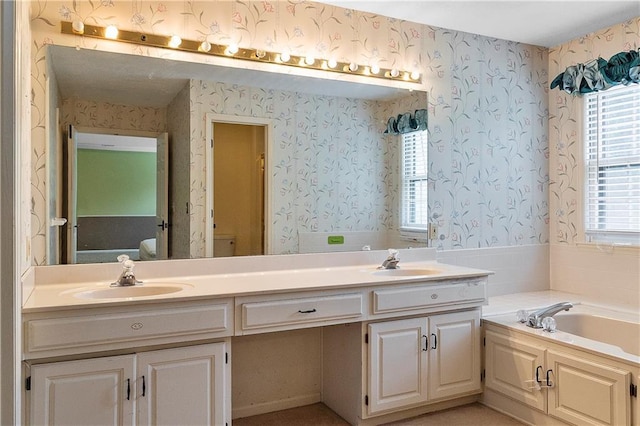 11207 W 109th St, Overland Park, KS 66210 - bathroom featuring a bath, double vanity, wallpapered walls, and toilet