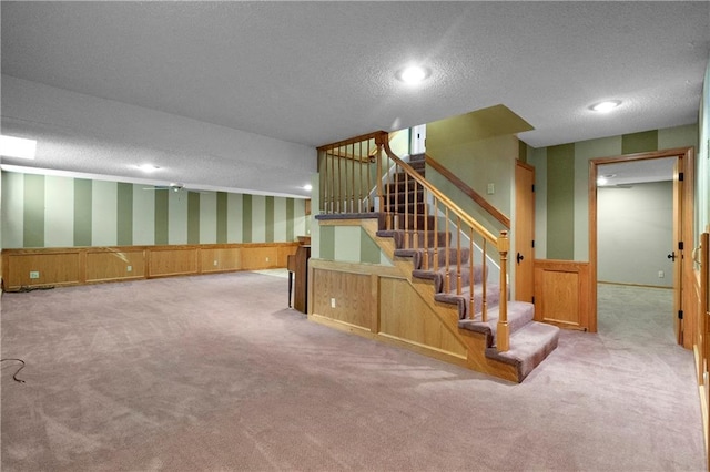 11207 W 109th St, Overland Park, KS 66210 - staircase with wallpapered walls, a textured ceiling, carpet floors, wainscoting, and recessed lighting