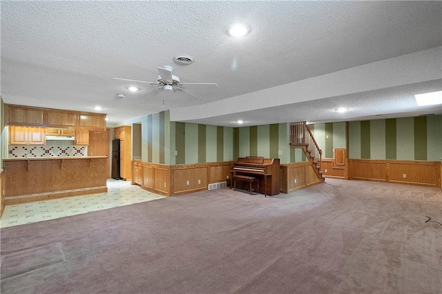 11207 W 109th St, Overland Park, KS 66210 - finished basement with wallpapered walls, light colored carpet, a wainscoted wall, recessed lighting, and a textured ceiling