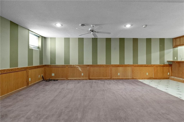 11207 W 109th St, Overland Park, KS 66210 - carpeted empty room featuring a wainscoted wall, a textured ceiling, ceiling fan, recessed lighting, and wallpapered walls