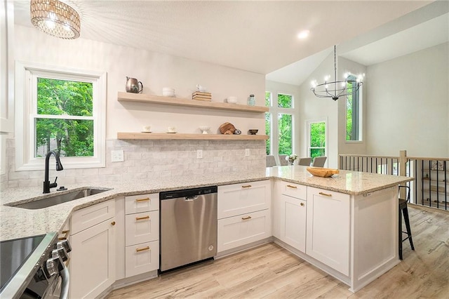 1345 NE Foxwood Dr, Lees Summit, MO 64086 - kitchen featuring stainless steel dishwasher, a chandelier, a sink, tasteful backsplash, and lofted ceiling