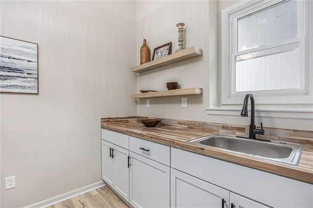 1345 NE Foxwood Dr, Lees Summit, MO 64086 - kitchen with a sink, butcher block countertops, baseboards, open shelves, and white cabinets