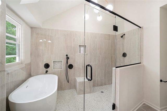 1345 NE Foxwood Dr, Lees Summit, MO 64086 - bathroom featuring a freestanding tub, a shower stall, vaulted ceiling, and tile walls