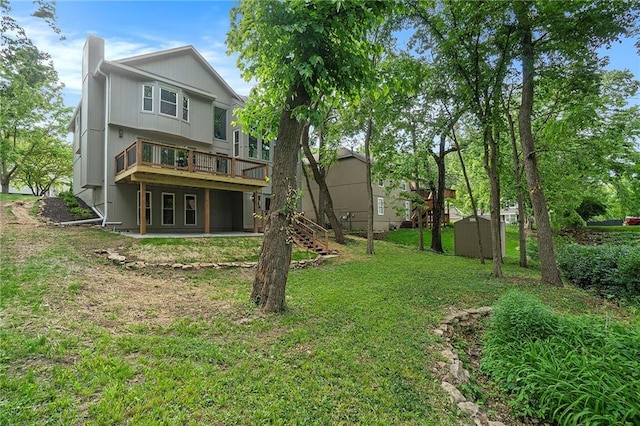 1345 NE Foxwood Dr, Lees Summit, MO 64086 - rear view of house with a yard, a wooden deck, stairway, and a chimney