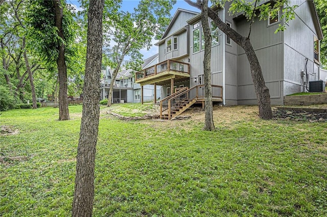 1345 NE Foxwood Dr, Lees Summit, MO 64086 - back of property featuring stairway, a wooden deck, a yard, and central air condition unit
