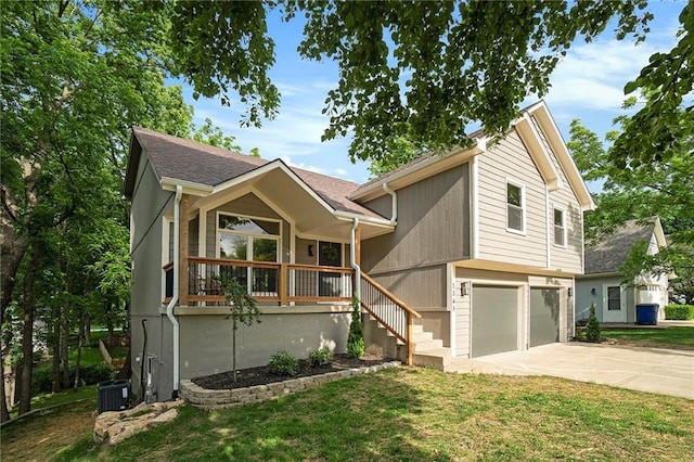 1345 NE Foxwood Dr, Lees Summit, MO 64086 - view of front of house with driveway, an attached garage, covered porch, central air condition unit, and a front lawn