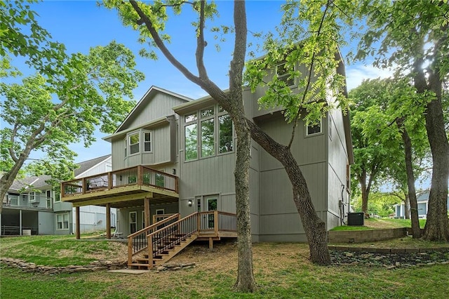 1345 NE Foxwood Dr, Lees Summit, MO 64086 - back of property featuring a wooden deck, central air condition unit, and stairway