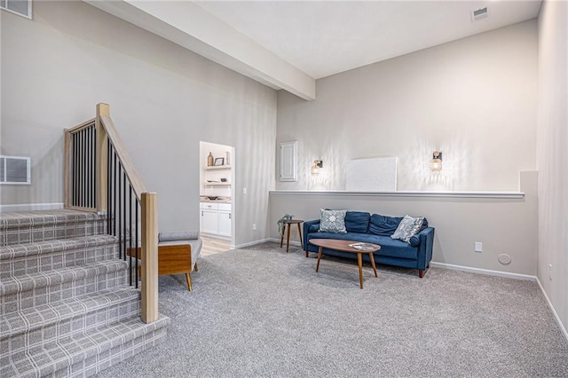 1345 NE Foxwood Dr, Lees Summit, MO 64086 - living room featuring carpet flooring, stairway, and baseboards