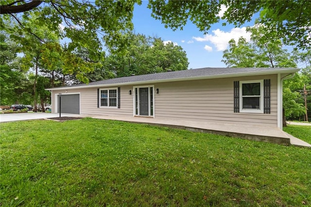 6201 N Topping Ave, Kansas City, MO 64119 - back of property with a garage, driveway, and a yard