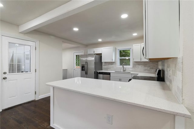 6201 N Topping Ave, Kansas City, MO 64119 - kitchen with stainless steel appliances, tasteful backsplash, dark wood-type flooring, recessed lighting, and a peninsula