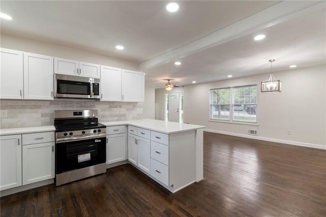 6201 N Topping Ave, Kansas City, MO 64119 - kitchen with stainless steel appliances, a peninsula, dark wood-style flooring, decorative backsplash, and light countertops