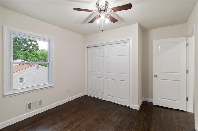 6201 N Topping Ave, Kansas City, MO 64119 - unfurnished bedroom with baseboards, dark wood-style floors, a closet, and a ceiling fan