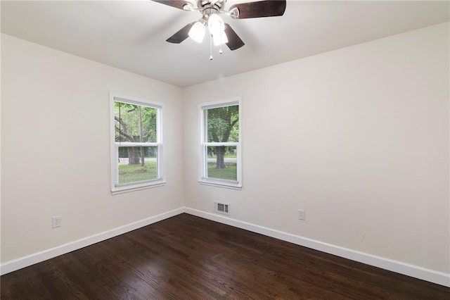 6201 N Topping Ave, Kansas City, MO 64119 - spare room featuring baseboards, dark wood-style flooring, and a ceiling fan
