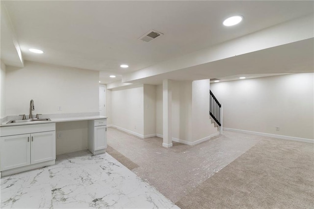 6201 N Topping Ave, Kansas City, MO 64119 - finished below grade area featuring a sink, recessed lighting, stairs, and baseboards