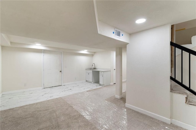 6201 N Topping Ave, Kansas City, MO 64119 - finished basement featuring baseboards, a sink, stairs, and recessed lighting
