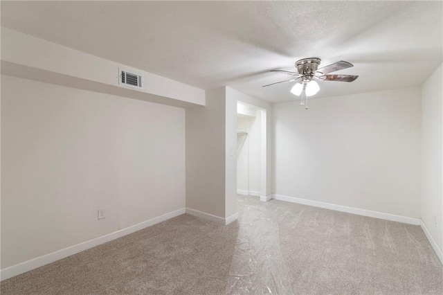 6201 N Topping Ave, Kansas City, MO 64119 - empty room with light colored carpet, ceiling fan, baseboards, and a textured ceiling
