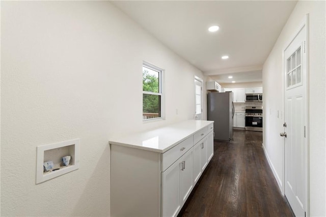 6201 N Topping Ave, Kansas City, MO 64119 - laundry area featuring dark wood-type flooring and recessed lighting