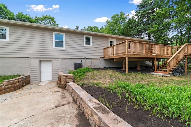 6201 N Topping Ave, Kansas City, MO 64119 - rear view of house with a deck, stairs, cooling unit, and a patio