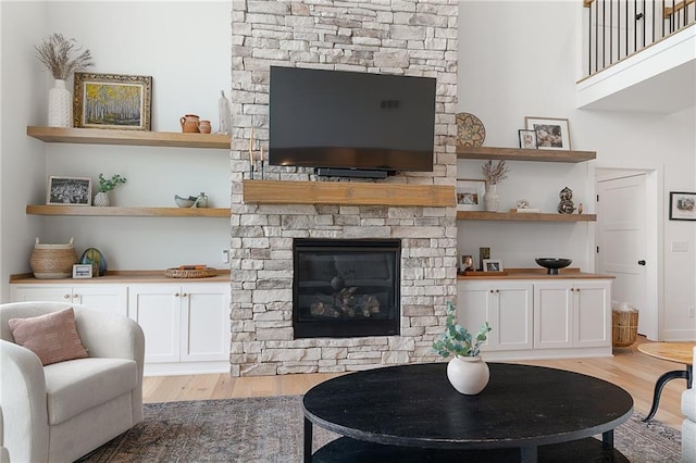 1120 Hillswick Ln, Raymore, MO 64083 - living room featuring light wood-style floors and a fireplace