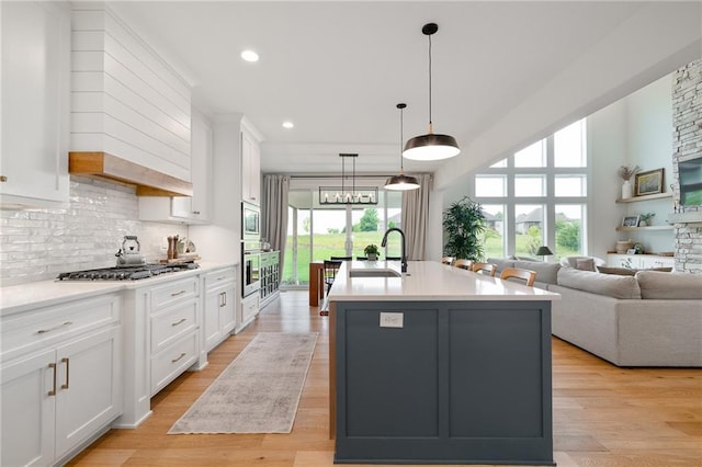 1120 Hillswick Ln, Raymore, MO 64083 - kitchen featuring a sink, white cabinetry, a kitchen island with sink, light countertops, and recessed lighting