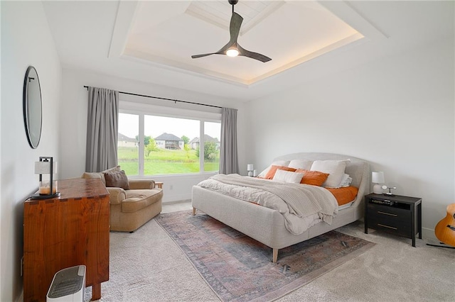 1120 Hillswick Ln, Raymore, MO 64083 - carpeted bedroom featuring a tray ceiling and ceiling fan