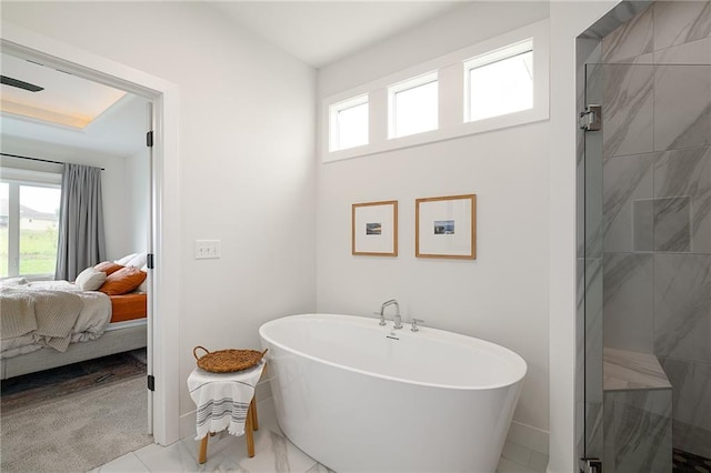 1120 Hillswick Ln, Raymore, MO 64083 - ensuite bathroom featuring a freestanding tub, a tile shower, and baseboards