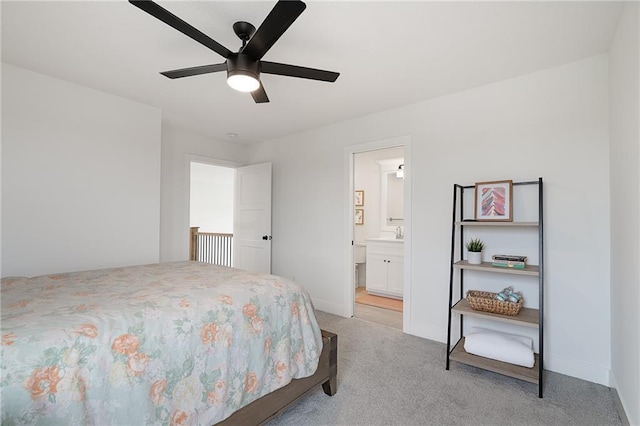 1120 Hillswick Ln, Raymore, MO 64083 - bedroom featuring light colored carpet, baseboards, connected bathroom, and a ceiling fan